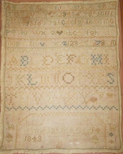 A framed sampler dated 1843, 31 x 24cm. Condition - poor to fair